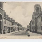 East Street in Wareham around the 1900s. The pump outside the Town Hall, one of eight providing drinking water until piped water arrived in 1906. The bell tower on the right was on the original Georgian Town Hall, rebuilt in 1870 by George Crickmay