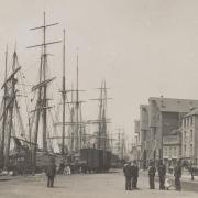 Poole's Town Quay in about 1895. The building with three jettied out upper storeys was Belben's Flour Mill, one of the first steam-powered mills in the country , next door is The Portsmouth Hoy pub, Pengey's rope, canvas and sack store and the Poole Arms