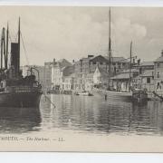 A view of Weymouth Harbour in 1900. Nearly all the buildings are still standing today including The Royal Oak and The Ship pubs, behind the barge is the covered Fish Market