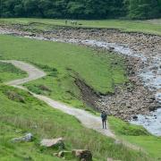 Nina Wadia walking along the River Swale to Keld in Yorkshire with selfie-stick.