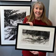 Artist in residence Wendy Rhodes in the gallery with some of her etchings and drawings