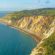 See the multi-coloured sand cliffs at Alum Bay