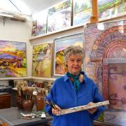 Susan Edwards in the studio working on a large painting of Kilpeck Church door, by Susan Edwards