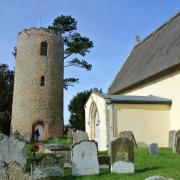 Bramfield church's round tower stands aloof in the graveyard