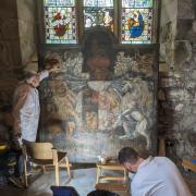 Expert art restorer Francis Dowling working on the CoA
