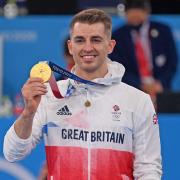 Max Whitlock show his gold medal in Toyko. Credit Garry Bowden/Sport in Pictures