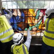 A framed section of a newly conserved 18th-century painted glass window is installed in the Gothic 'tomb' at the National Trust's The Vyne near Basingstoke