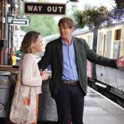 Actors Kris Marshall and Sally Bretton on the platform at South Devon Railway for BBC One's new series of Beyond Paradise
