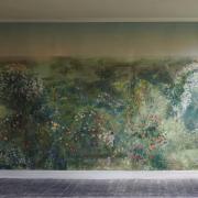 Flora beside one of the large-scale murals she has handpainted for a Dorset home