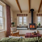 The large woodburner and bespoke bench seating either side creates a focal point of the living space in the new extension