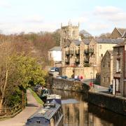 A branch of the Leeds Liverpool Canal runs alonside the stone buildings in Skipton in the Yorkshire Dales..