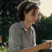 Imani writing in the garden of her family home in Piddlehinton
