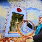 Glassmaker / illiustrator Shen Chokyi with some of her glasswork next to her Thomas Telford built cottage near Eskdalemuir