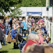 Crowds watch the showjumping.
