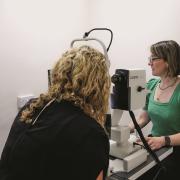 Jacinda Powell, practice manager, performing OCT scan in Yeovil