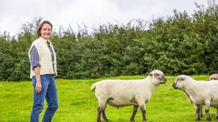 Justine Lee modelling one of her gilets alongside some Dorset Down sheep at Rampisham Hill Farm. Their wool pads out the quilted gilet. (Photo: Tom Lee)